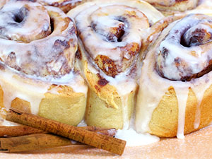 closeup of three frosted cinnamon rolls